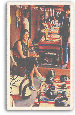 A Native American (Indian) woman sells her authentic, handcrafted wares at the annual world famous Indian Market on the portal of the Palace of the Governors in downtown Santa Fe, New Mexico.